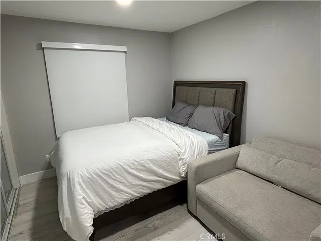 a bedroom with a bed and a mirror