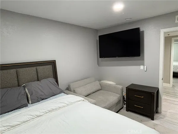 a bedroom with a bed and a flat screen tv