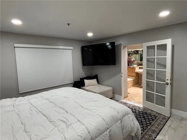 a bedroom with a bed and a flat screen tv