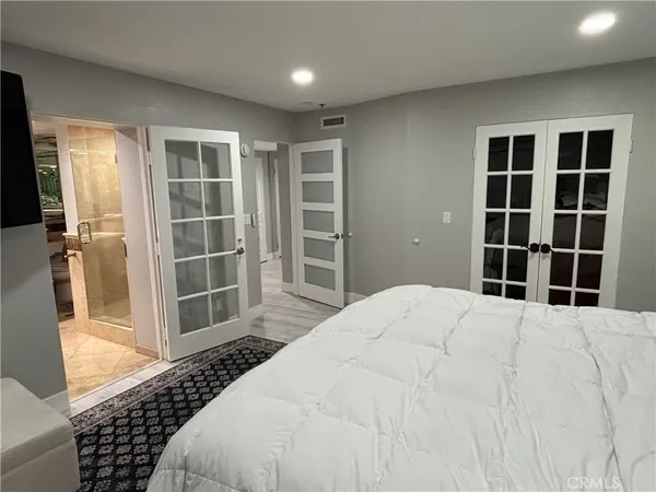 a large bed sitting in a room next to a window