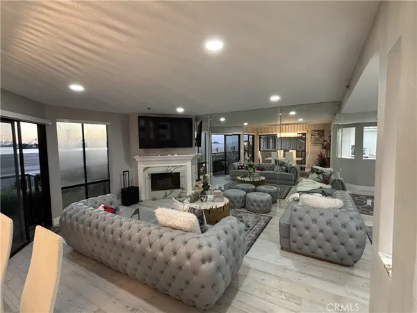 a living room with furniture fireplace and flat screen tv
