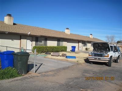 21368 Powhatan Road Apple Valley, CA 92308 - Photo 1 of 1 a view of a patio with dining table and chairs under an umbrella