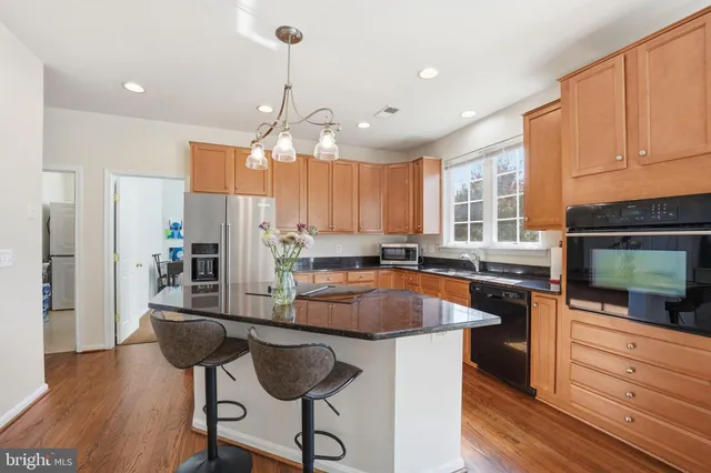 a kitchen with stainless steel appliances granite countertop a stove a sink and a granite counter tops
