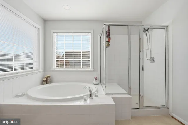 a bedroom with furniture and a wooden floor