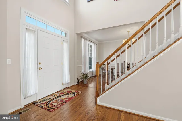 a view of entryway and hall with wooden floor