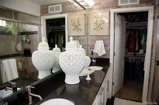 a living room with furniture a fireplace and wall painting