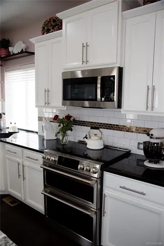 a kitchen with a stove and a microwave