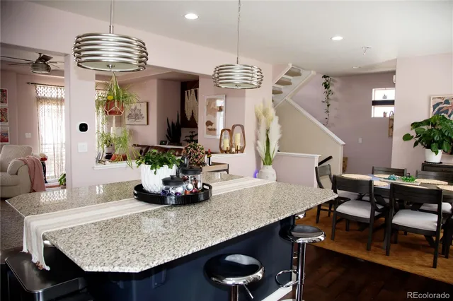 a dining room with furniture and view kitchen