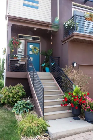 a view of a house with potted plants