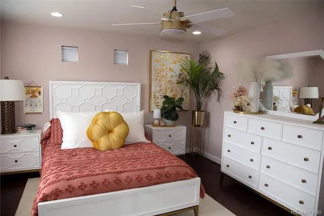 a bedroom with a bed and a potted plant