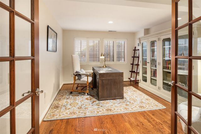 a dining room with furniture and a floor to ceiling window