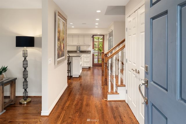 a view of a living room with furniture and wooden floor