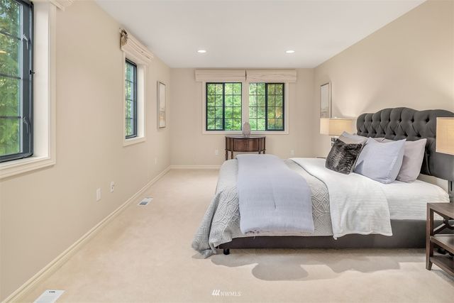 a bedroom with a bed and a large window