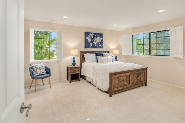 a bedroom with a bed and a painting on the wall