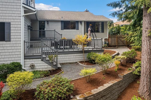 an aerial view of residential houses with outdoor space and lake view