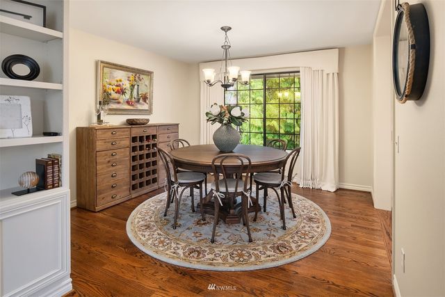 a dining room with furniture a window and wooden floor