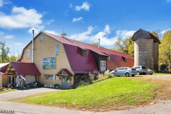 a front view of house with yard and car parked