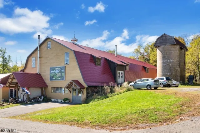 a front view of house with yard and car parked