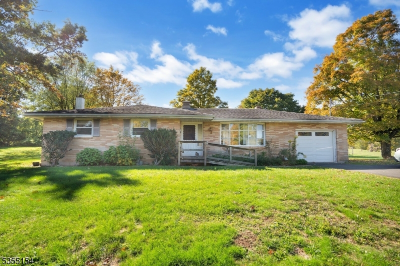 369 Stamets Road Milford, NJ 08848 - Photo 5 of 12 a front view of a house with a garden and yard
