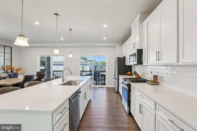 a view of kitchen with cabinets table and chairs