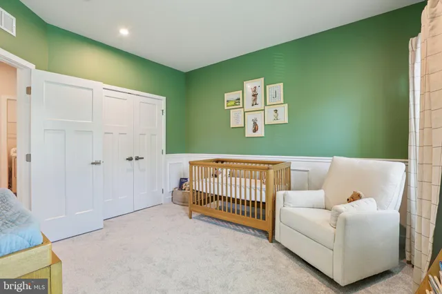 a bathroom with double vanity sink a mirror and a shower