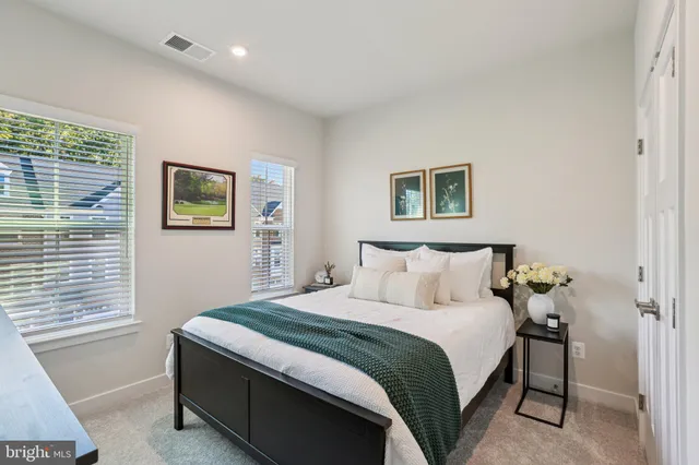 a bedroom with a bed and a night stand