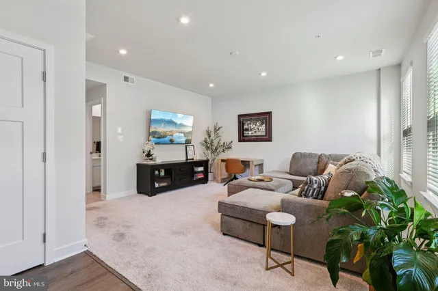 a living room with furniture and a white floor