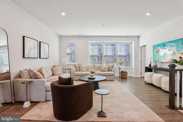 a living room with furniture and kitchen view