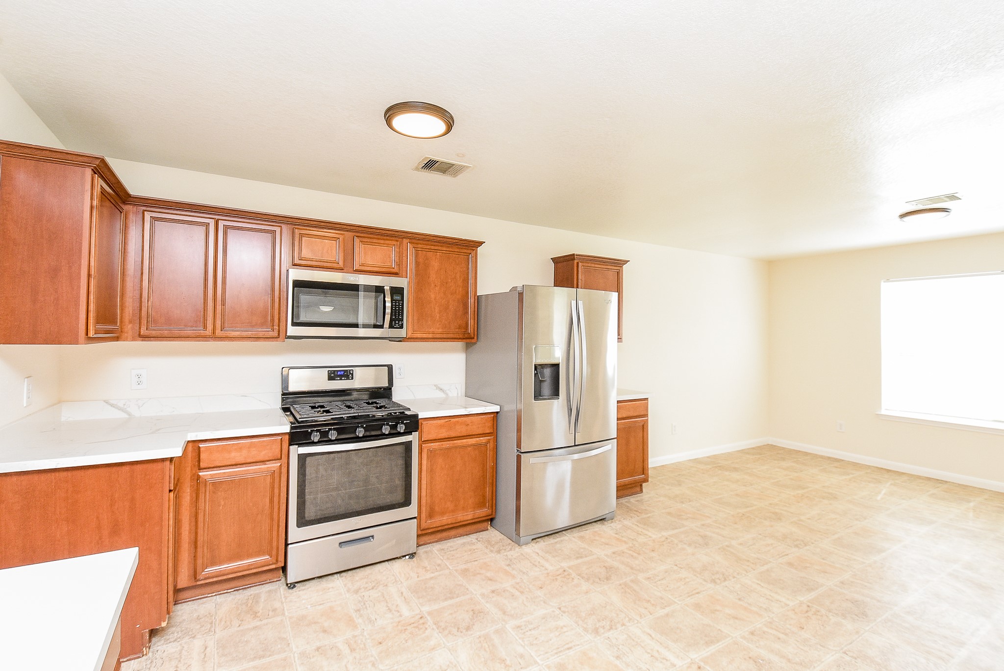 32406 Cross Spring Park Lane Conroe, TX 77385 - Photo 14 of 32 a kitchen with stainless steel appliances granite countertop a stove a refrigerator and a sink with cabinets