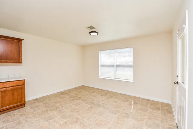 a view of an empty room with a window