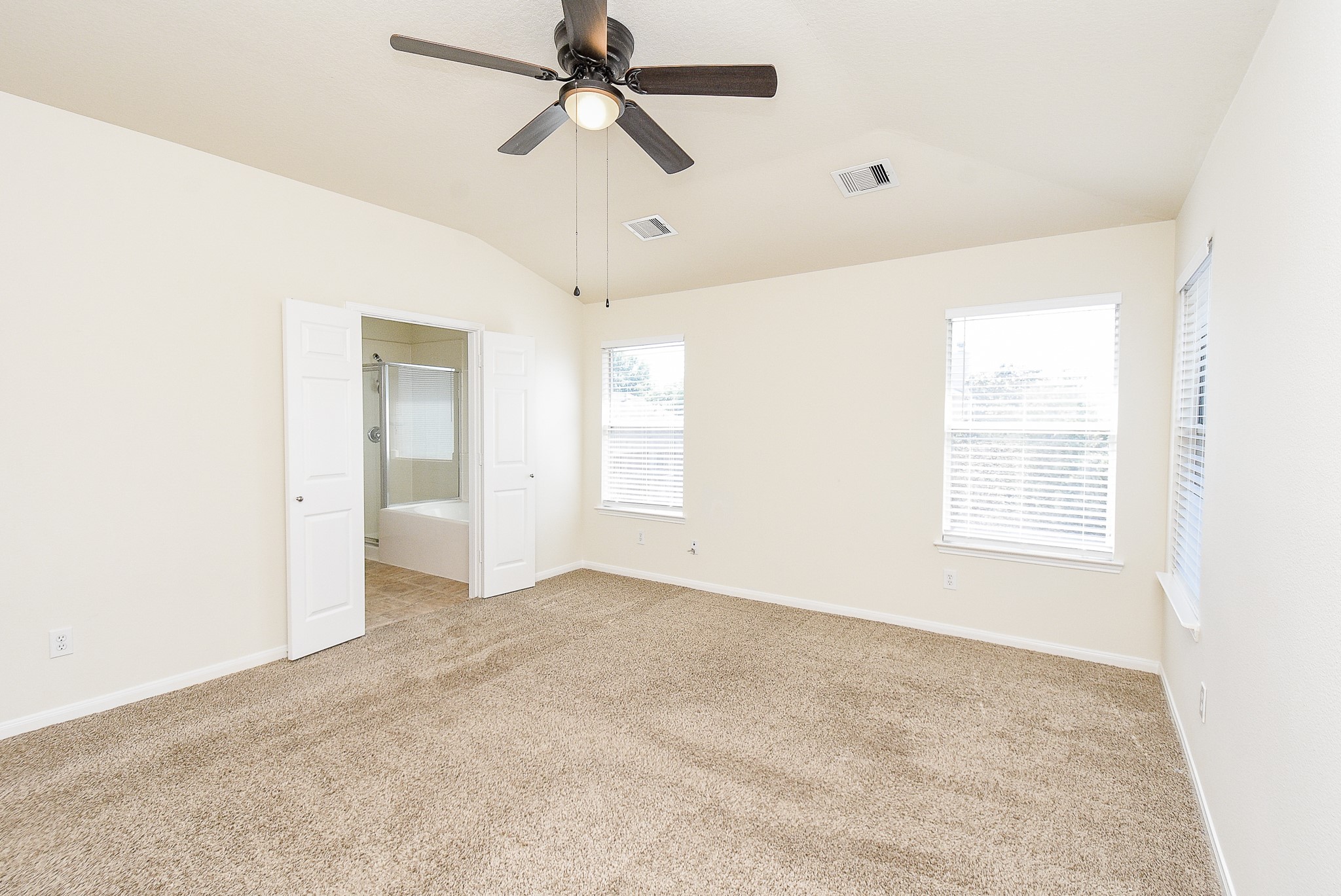 32406 Cross Spring Park Lane Conroe, TX 77385 - Photo 20 of 32 a view of a big room with a ceiling fan and windows in a room