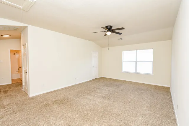 a view of empty room with ceiling fan