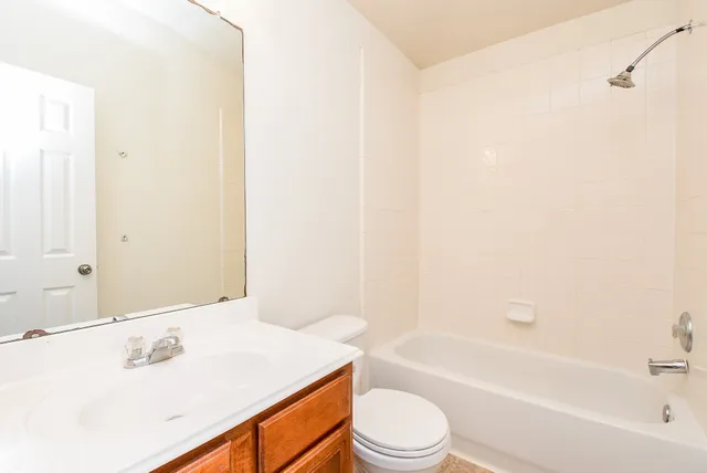 a bathroom with a sink a toilet and bathtub