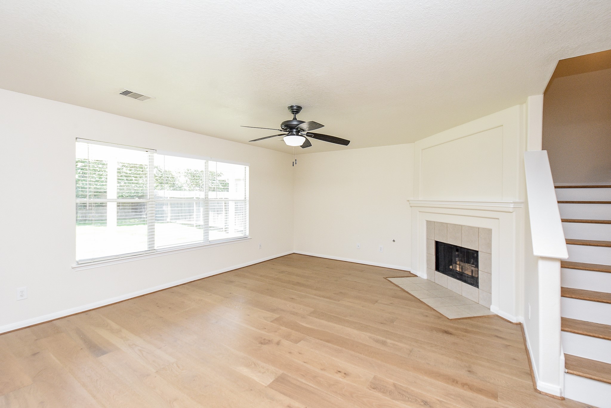 32406 Cross Spring Park Lane Conroe, TX 77385 - Photo 7 of 32 a view of an empty room with a fireplace and a window