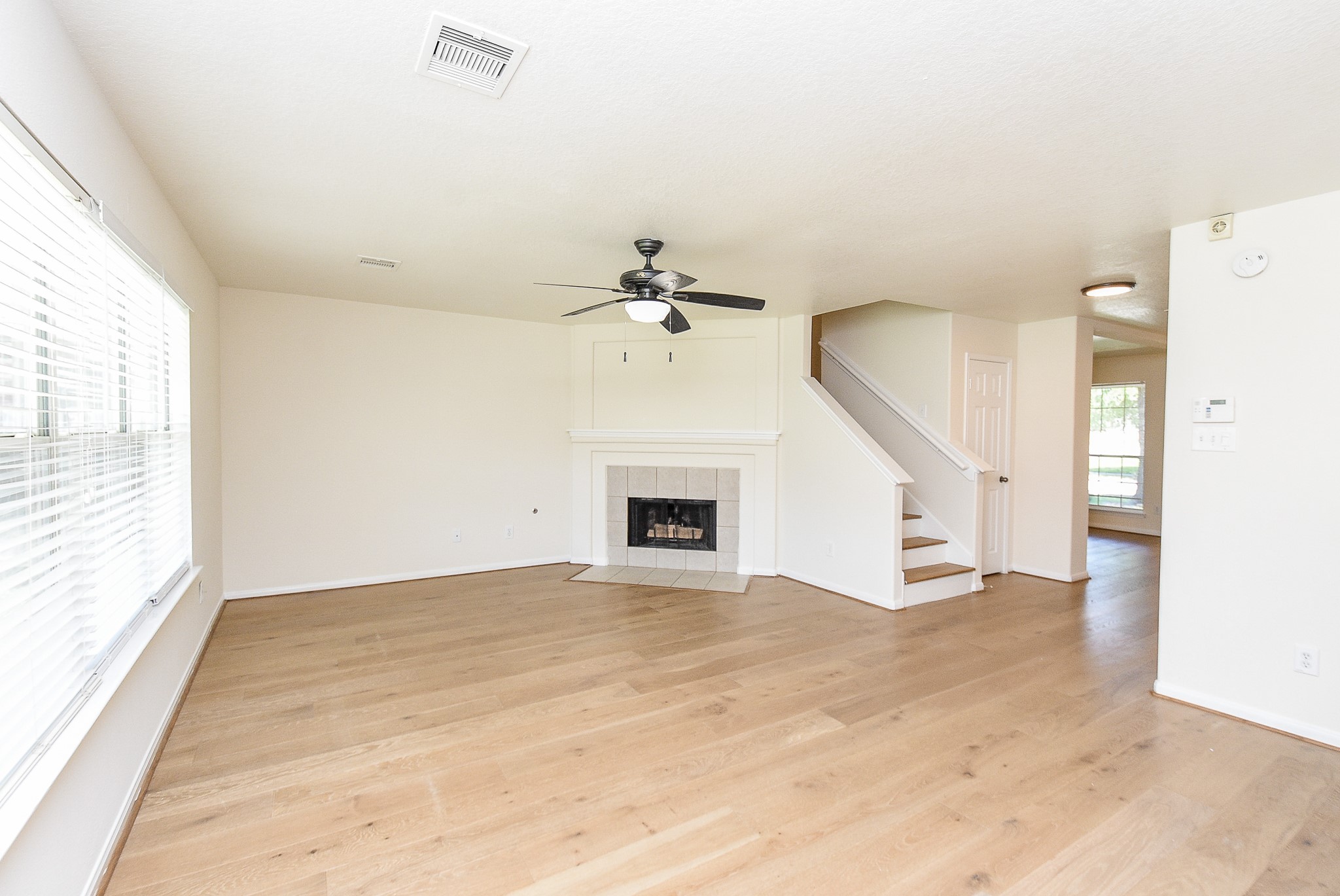 32406 Cross Spring Park Lane Conroe, TX 77385 - Photo 8 of 32 a view of an empty room with a fireplace and a window