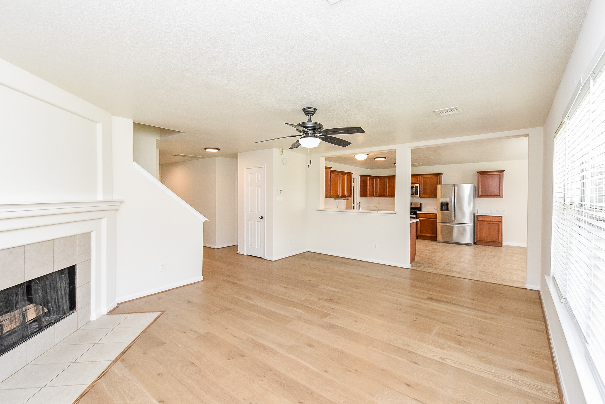 32406 Cross Spring Park Lane Conroe, TX 77385 - Photo 9 of 32 a view of a livingroom with wooden floor and a kitchen