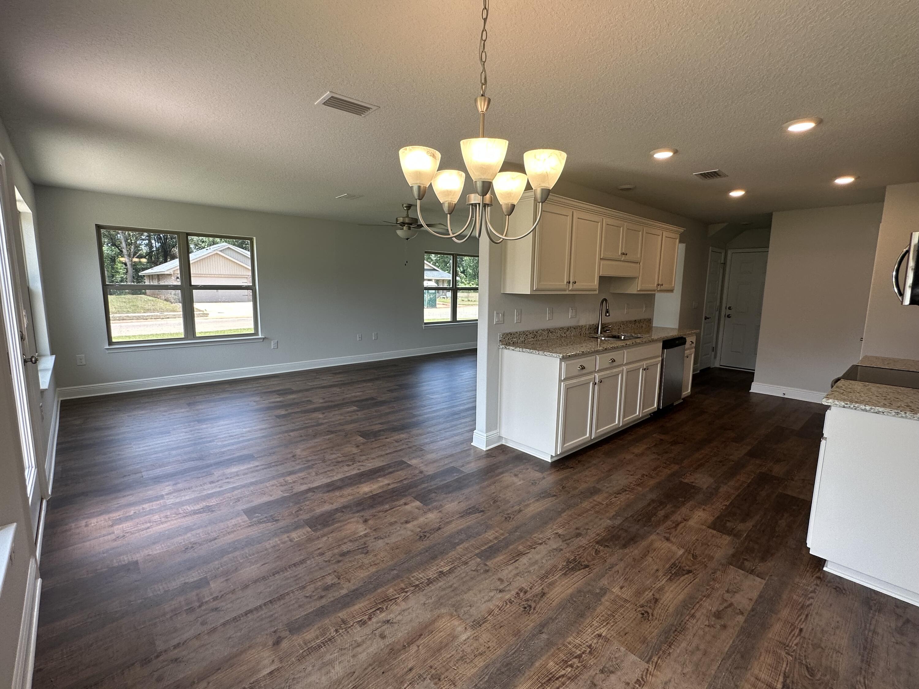 188 Ridgeway Circle Crestview, FL 32536 - Photo 11 of 22 a kitchen with stainless steel appliances granite countertop wooden floors and a view of living room