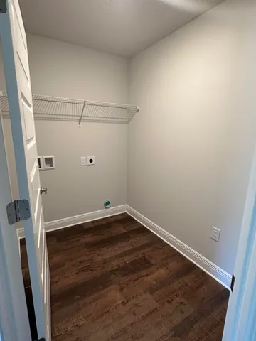 a view of a room with wooden floor and white walls