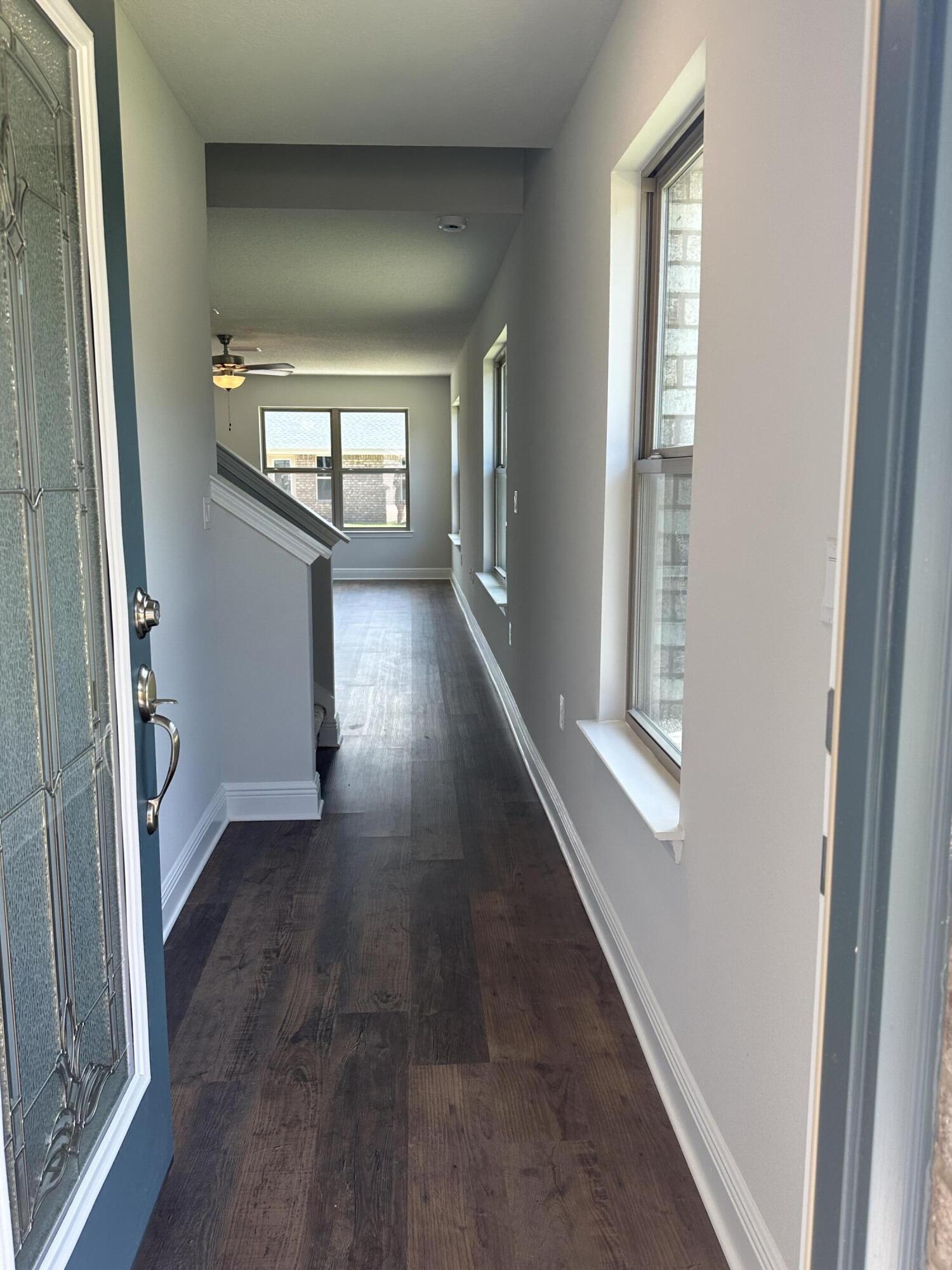 188 Ridgeway Circle Crestview, FL 32536 - Photo 3 of 22 wooden floor in a empty room with windows