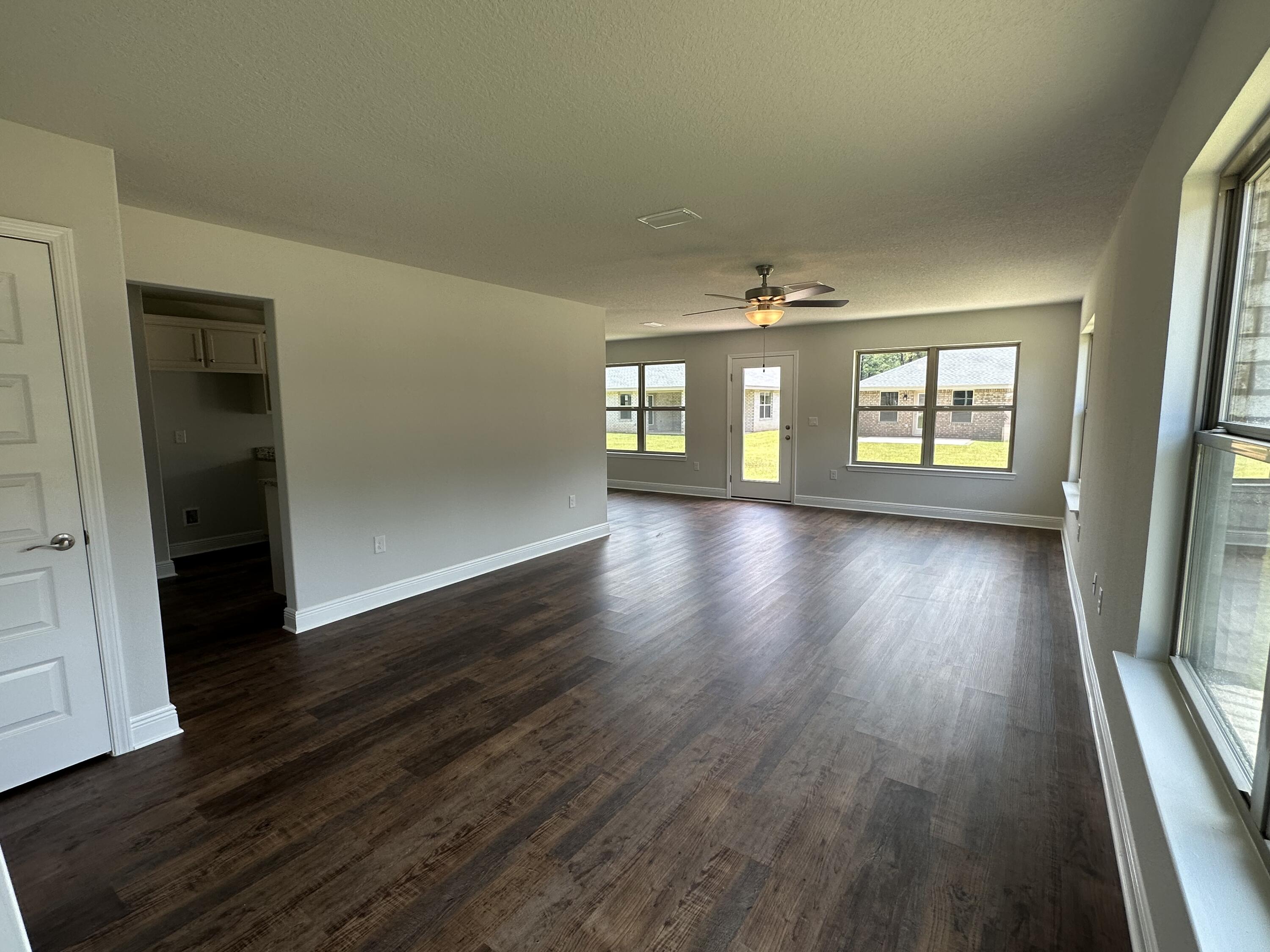 188 Ridgeway Circle Crestview, FL 32536 - Photo 5 of 22 wooden floor in an empty room with a window