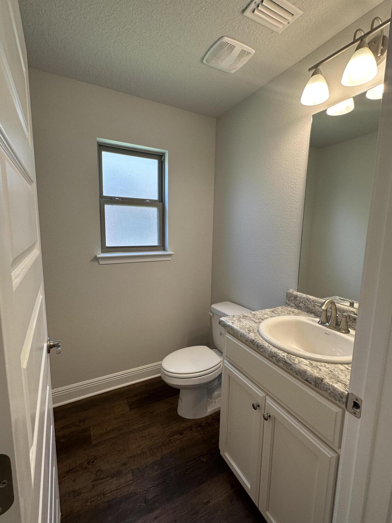 188 Ridgeway Circle Crestview, FL 32536 - Photo 6 of 22 a bathroom with a granite countertop toilet sink and mirror