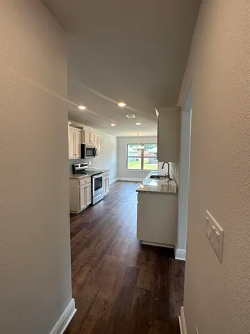 a view of kitchen and wooden floor