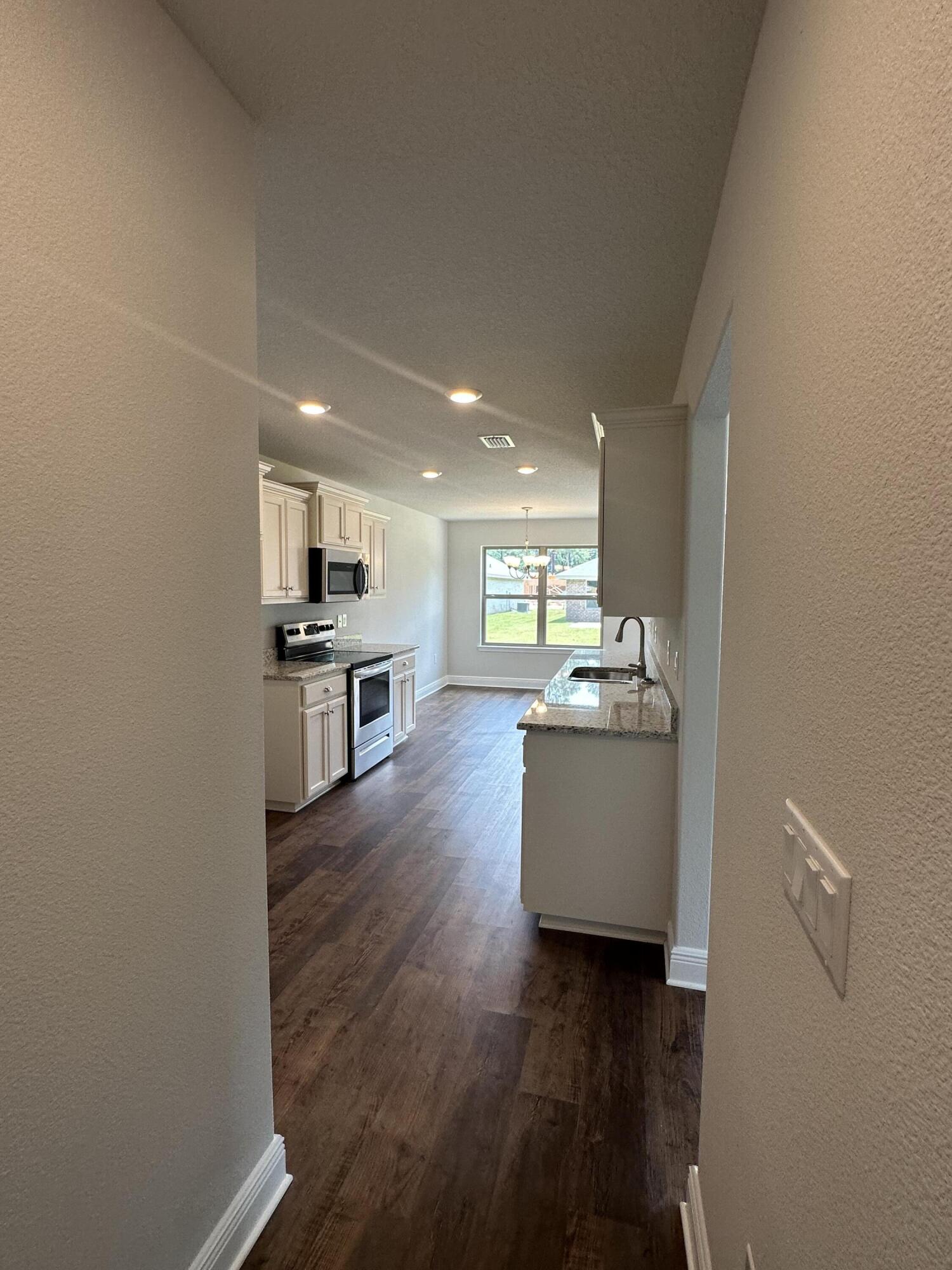 188 Ridgeway Circle Crestview, FL 32536 - Photo 7 of 22 a view of kitchen and wooden floor