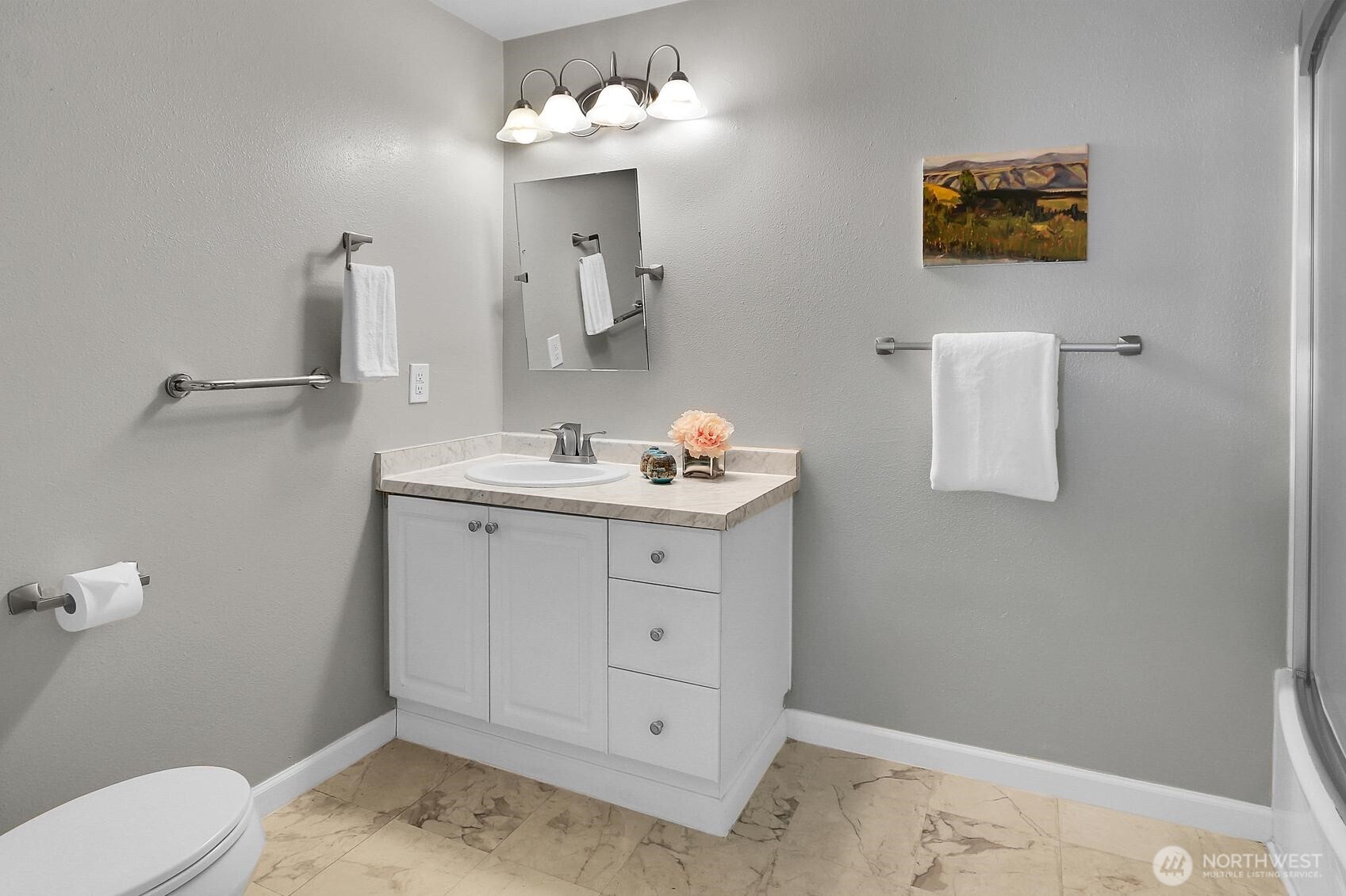 12505 4th Avenue West, Unit 1040 Everett, WA 98204 - Photo 15 of 20 a bathroom with a sink toilet and mirror