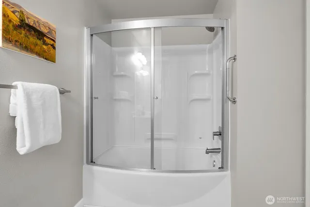 a bathroom with a glass shower door