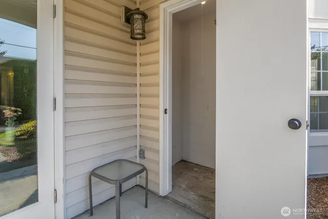 a bathroom with a shower and a chair