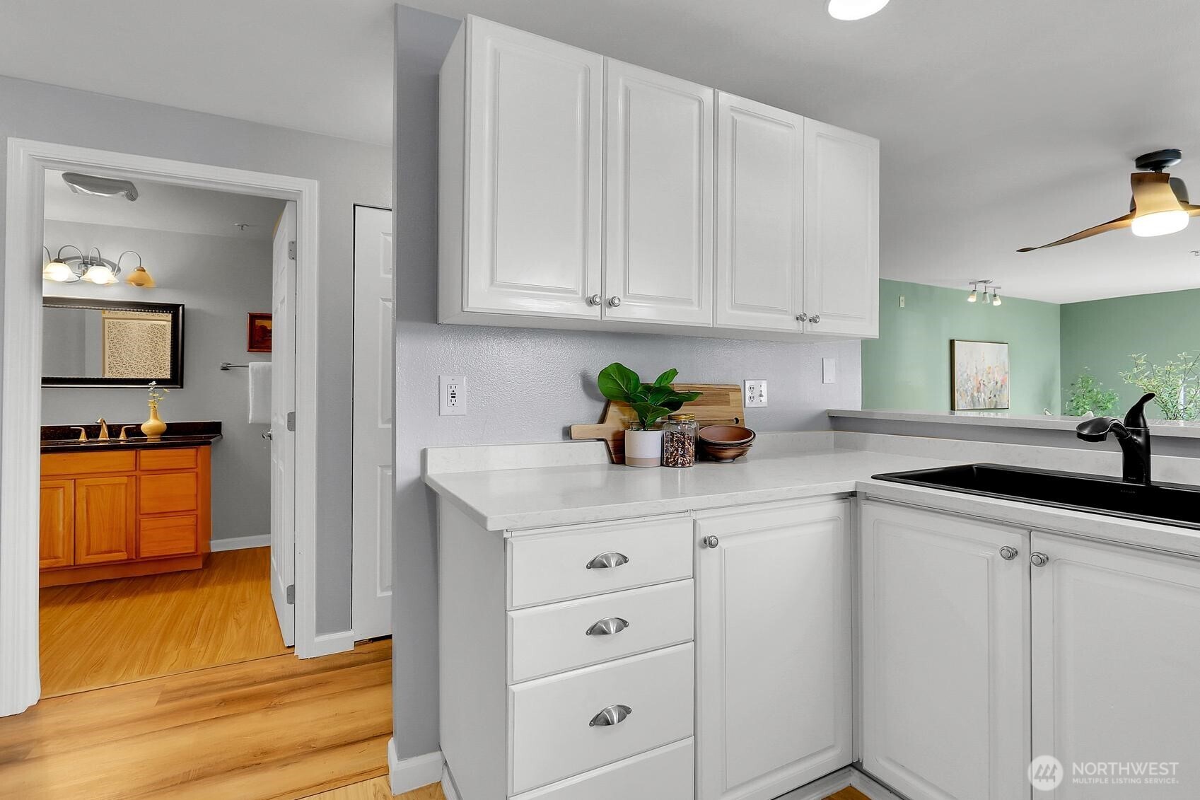 12505 4th Avenue West, Unit 1040 Everett, WA 98204 - Photo 6 of 20 a kitchen with granite countertop white cabinets and white appliances