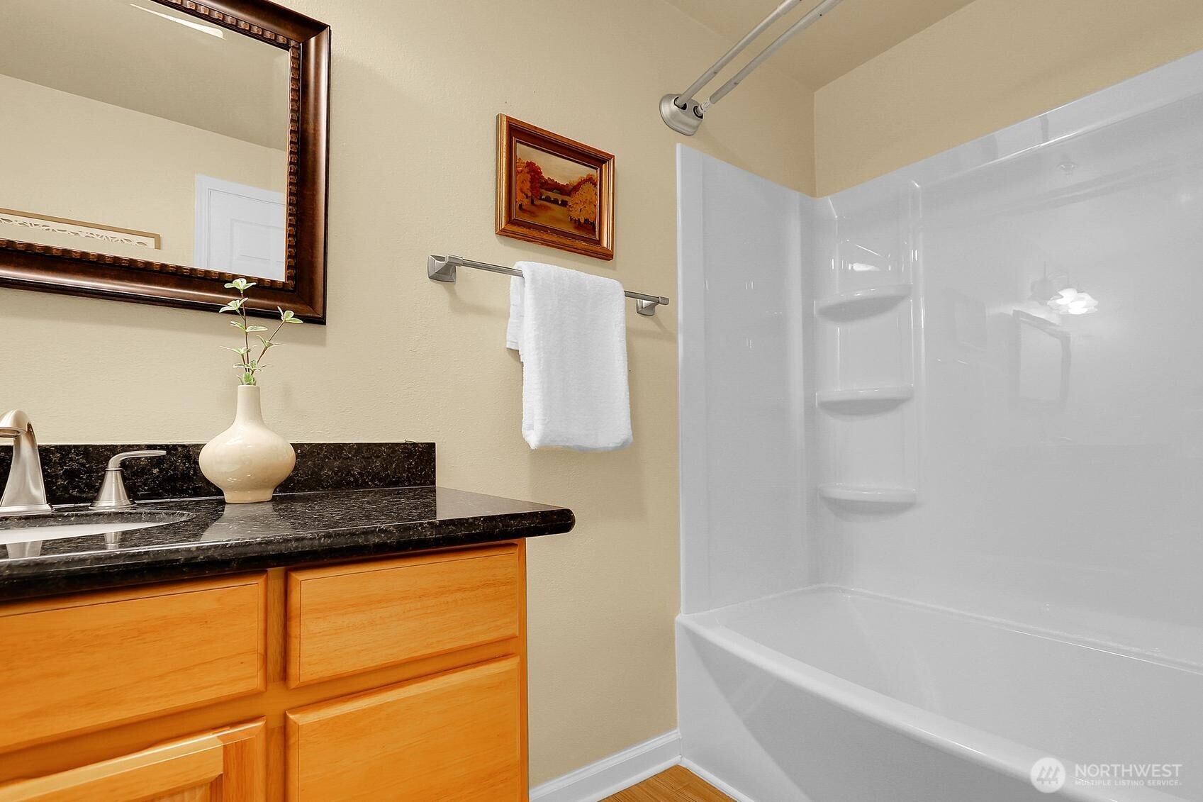 12505 4th Avenue West, Unit 1040 Everett, WA 98204 - Photo 10 of 20 a bathroom with a granite countertop sink and a mirror