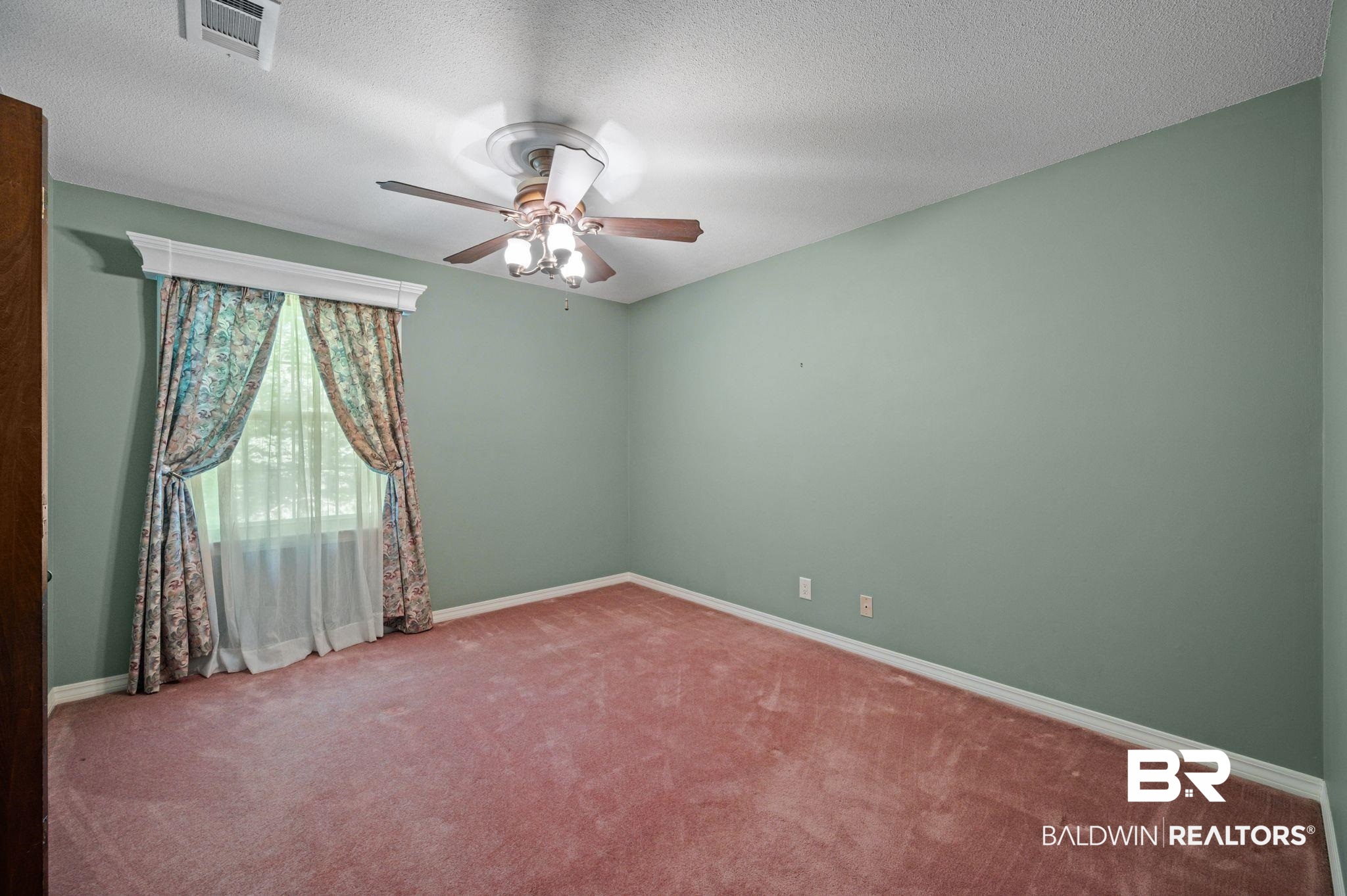 950 Walter Smith Road Mobile, AL 36695 - Photo 23 of 51 Empty room with carpet flooring, ceiling fan, baseboards, and a textured ceiling