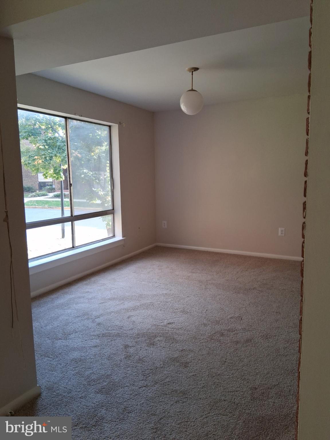 8479 Greenbelt Road, Unit 102 Greenbelt, MD 20770 - Photo 11 of 14 a view of an empty room with a window